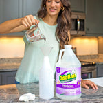 woman pouring liquid into a funnel over a spray bottle next to an odoban lavender disinfectant jug on a kitchen counter