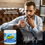 Man on a leather couch lighting a cigar with an OdoBan odor absorber jar pictured and text claiming it eliminates smoke odors.