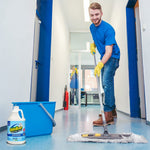 Cleaning scene showing a person mopping a hallway floor with an OdoBan jug and blue bucket placed nearby.
