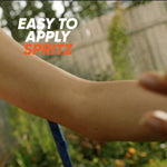 Close-up of a forearm being sprayed outdoors with overlaid text 'Easy to apply spritz'