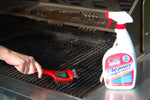 Spray bottle of Oil Eater Cleaner Degreaser positioned by a grill while a person scrapes grates with a red scraper