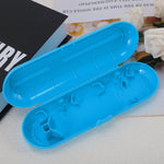 Open empty blue toothbrush travel case showing interior clips and ventilation holes on a tabletop.