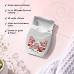 Open GuruNanda expandable floss container with floss pulled out and list of product features on a pink background