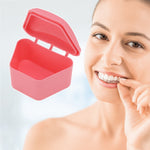 Open pink trapezoidal retainer case floating next to a smiling person holding a clear aligner