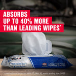 Opened STP Pro‑Series wipes pack with a white wipe pulled out and bold text claiming higher oil absorption over blurred engine background