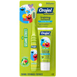 Green blister pack showing Orajel Naturals Sesame Street training toothpaste tube and matching green toddler toothbrush with Elmo art