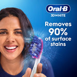 Smiling person holding an Oral-B toothbrush with copy claiming it removes 90% of surface stains