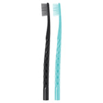 Two toothbrush handles photographed upright on white background, one black and one teal, showing diamond textured grip.