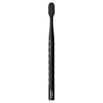 Full-length studio shot of a black Oral‑B toothbrush with a textured wavy handle on a white background.