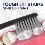 Close-up illustration of a black toothbrush head brushing teeth with caption ‘Tough on stains gentle on gums’.