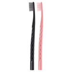 Studio photo of two Oral-B toothbrush handles, one black and one coral/pink, shown upright on a white background.