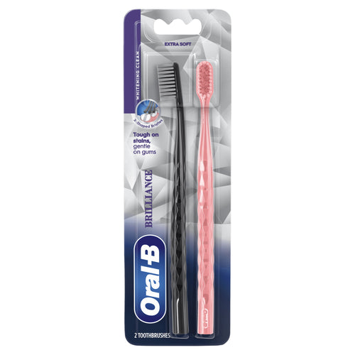 Retail blister pack of two Oral‑B Brilliance toothbrushes showing black and coral textured handles and packaging artwork