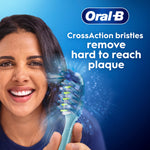 Close-up lifestyle graphic of a smiling person holding an Oral-B CrossAction toothbrush against a blue background