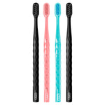 Four Oral-B toothbrushes aligned on white background showing textured handles in black, coral and teal