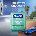Single green Oral-B Glide Comfort Plus floss container shown in a split lifestyle background with sink and keys.