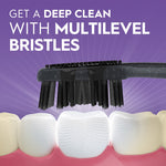 Black Oral-B toothbrush head demonstrating multilevel bristles over stylized teeth on a purple background promoting deep clean