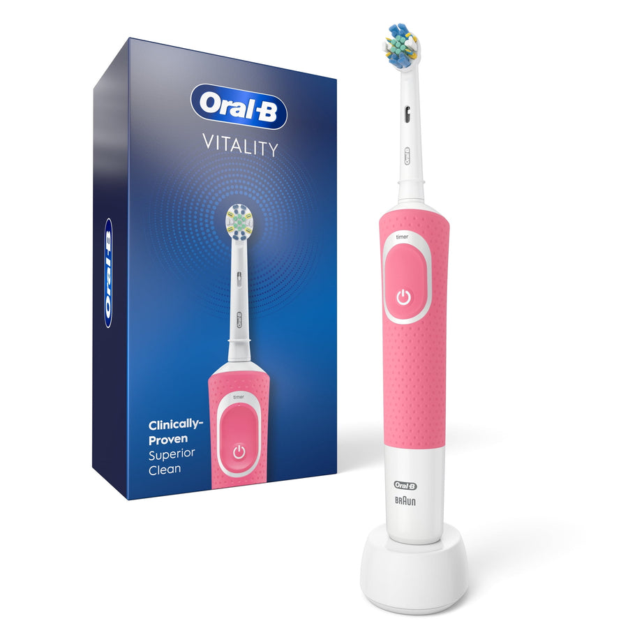 Pink Oral‑B Vitality electric toothbrush standing on charger next to its blue retail box