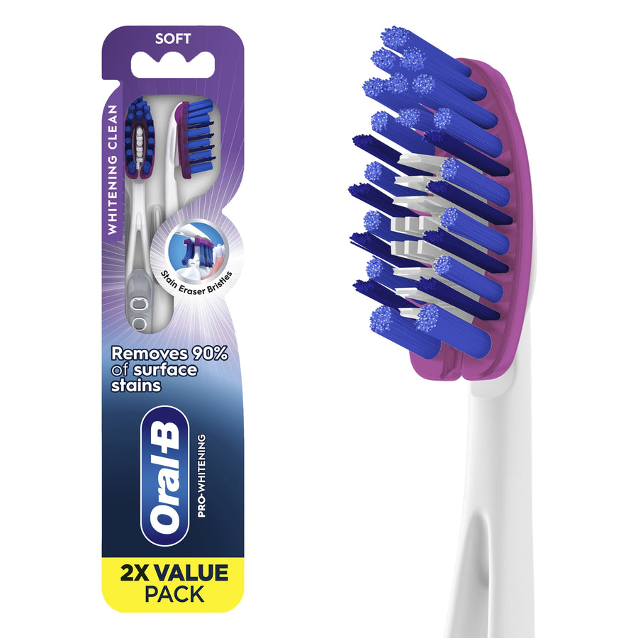 Oral-B Pro-Whitening toothbrush 2-pack in purple-blue packaging showing two soft-bristle toothbrushes and brand logo