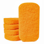 Close-up of a stack of bright orange rectangular scouring pads with rounded corners on white background.