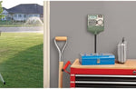 Orbit Easy Dial timer mounted above a toolbox with a yard and sprinklers visible outside