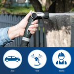 Hand-held Orbit Pro adjustable hose nozzle spraying a steady stream with outdoor fence and tree background