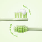 Close-up infographic of a green toothbrush head showing soft bristles and slim brush head with descriptive curved text on pale background.