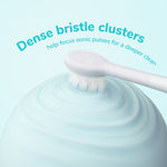 Toothbrush head pressing into a swirled surface with headline 'Dense bristle clusters' in teal text