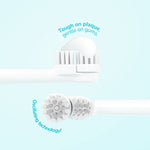 Close-up of a white oscillating kids brush head with a dollop of toothpaste on the bristles and a second head shown edge-on.