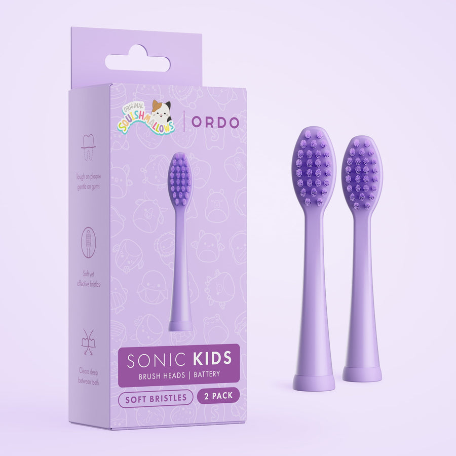 Purple Ordo kids sonic replacement brush heads next to matching branded packaging with Squishmallows logo