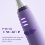 Angled view of a purple Ordo toothbrush handle with three progress lights and decorative bat-wing buttons