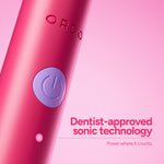 Close-up macro of the pink Ordo toothbrush body showing embossed ORDO logo and a purple power button with accompanying dentist-approved sonic technology text