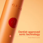 Close-up of Ordo Sonic Edge peach toothbrush body showing embossed logo and power button