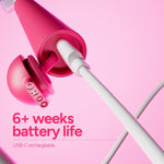 Close-up image of the pink toothbrush base with USB-C cable plugged in and overlay text highlighting ‘6+ weeks battery life’