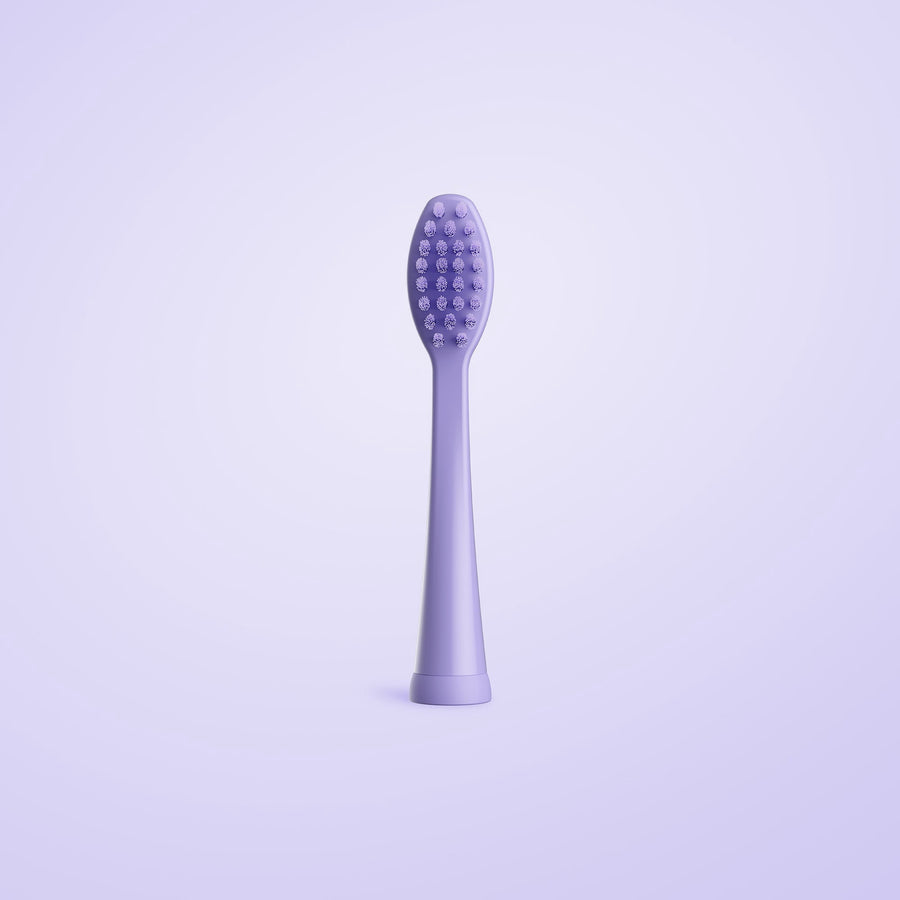 Ordo Sonic Kids replacement toothbrush head in solid lilac-purple shown upright on a soft purple background.