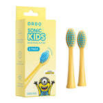 Boxed ORDO Sonic Kids Minions yellow replacement brush heads shown next to two yellow brush head inserts with blue bristles.