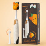 Ordo Sonic Kids rechargeable toothbrush next to product box and extra brush head, pumpkin Squishmallow cap shown