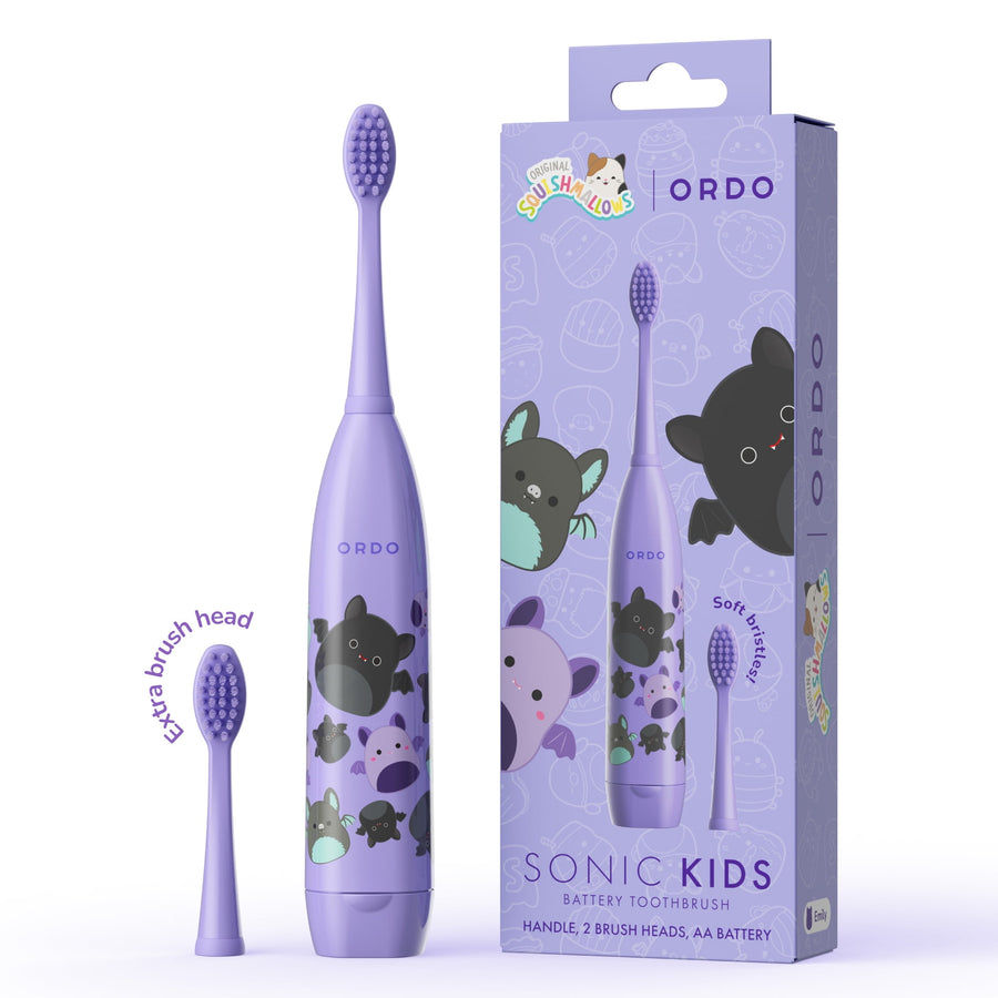 Purple Ordo Sonic Kids battery toothbrush with Squishmallows Emily characters shown next to its matching retail box and extra head