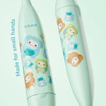 Close-up of two mint Ordo toothbrush handles showing Squishmallows character pattern and ORDO logo on a soft green background