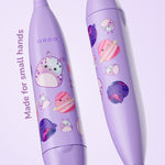 Close-up of two purple Ordo toothbrush handles showing Squishmallows Daxxon and planet character stickers and 'Made for small hands' text