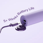 Close-up of a purple toothbrush base with USB-C charging port and cable showing battery life claim