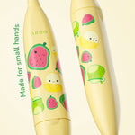 Close-up of two yellow Ordo kids toothbrush handles decorated with cute fruit Squishmallows characters