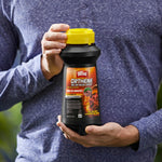Lifestyle image of a person holding an Ortho Orthene bottle in both hands, showing the product label and yellow cap.