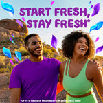 Smiling couple outdoors with purple and blue petal graphics and 'Start fresh, stay fresh' promotional text for Gain scent booster
