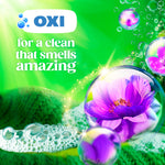 Bubbles and a purple flower over a green textured background with OXI branding and clean-smelling claim