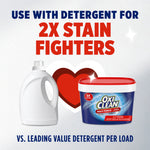 Graphic showing OxiClean tub alongside a detergent bottle and text '2X STAIN FIGHTERS' and 'use with detergent'