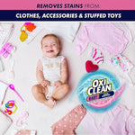 Smiling baby lying on a blanket surrounded by clothing and toys with OxiClean Baby logo and a header about removing stains from clothes and toys.
