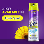 Promotional graphic showing OxiClean Foam-Tastic can with 'also available in Fresh Scent' callout and a yellow flower on purple background