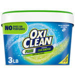 Close-up of OxiClean Free blue tub with green lid showing brand logo and 'No dyes or perfumes' label on front.