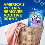 OxiClean pouch arranged in a wicker laundry basket with folded garments beside bold text claiming America's #1 stain remover additive brand