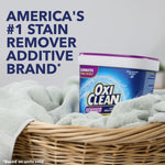 OxiClean Odor Blasters tub nestled in a wicker laundry basket on towels with bold brand headline text